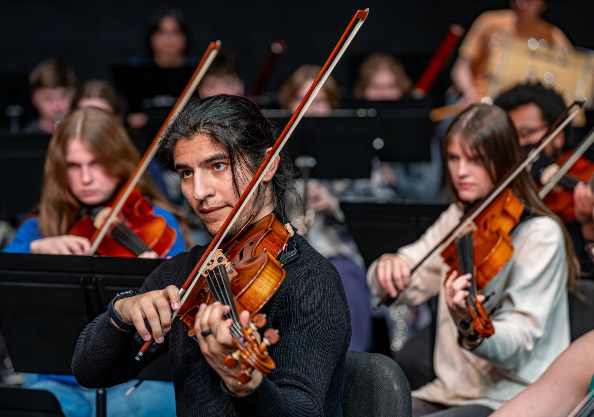 Violist Cruz Pena (front) plays during a rehearsal of Dr. Joel Schut’s MUS 103 Grand Valley Symphony Orchestra at the Louis Armstrong Theatre on February 23.